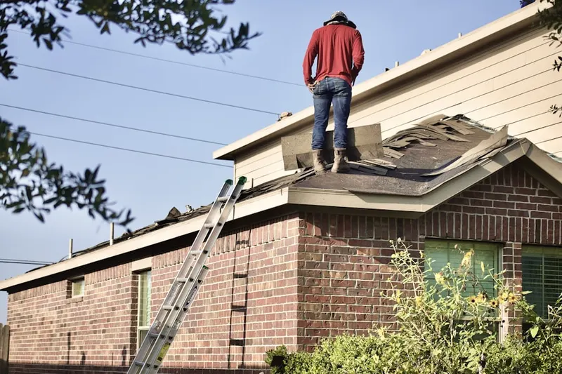 Professional roofer working on a residential roof in Goshen Crossing